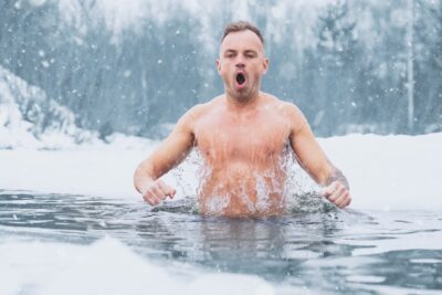 Man swimming in a frozen lake